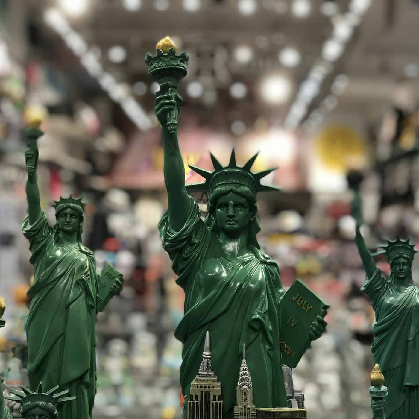 A row of identical souvenir Statue of Liberty replicas